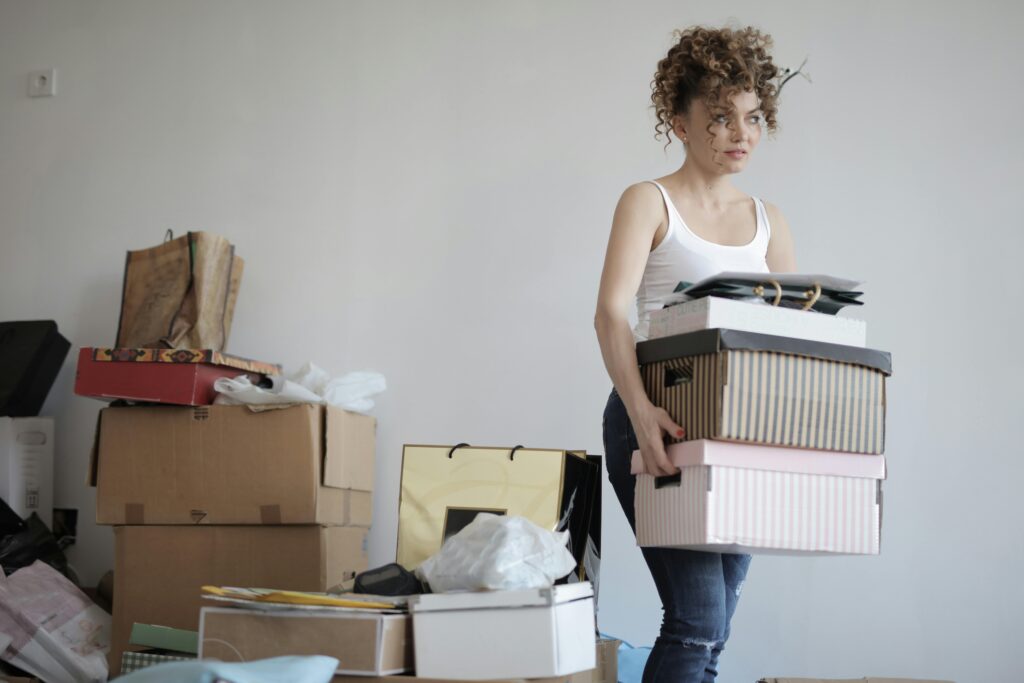 woman carrying moving boxes