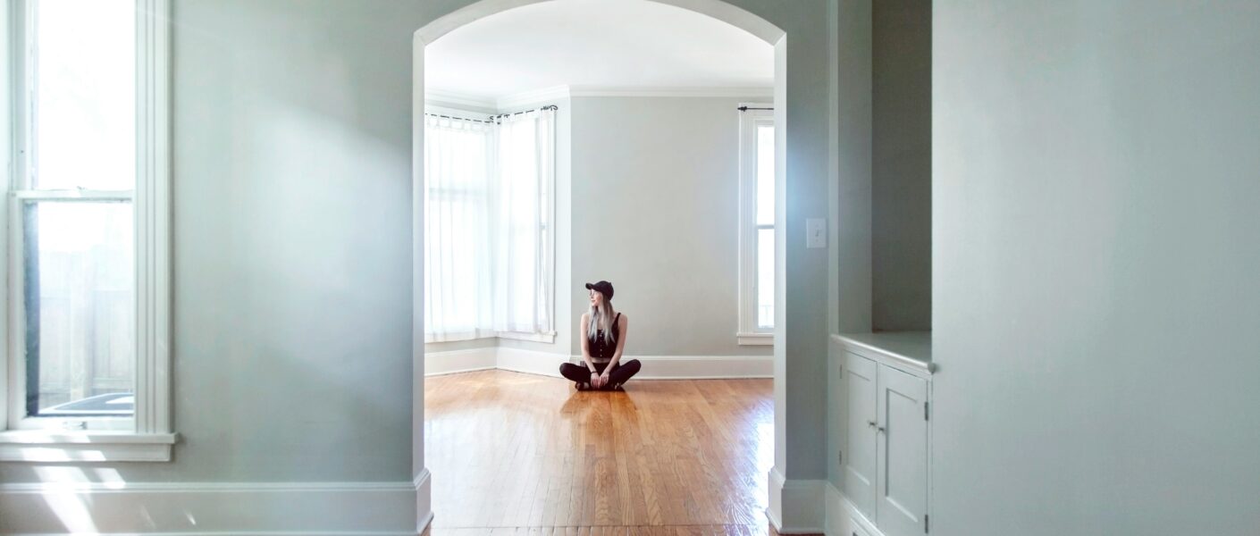 Person sitting in an empty home